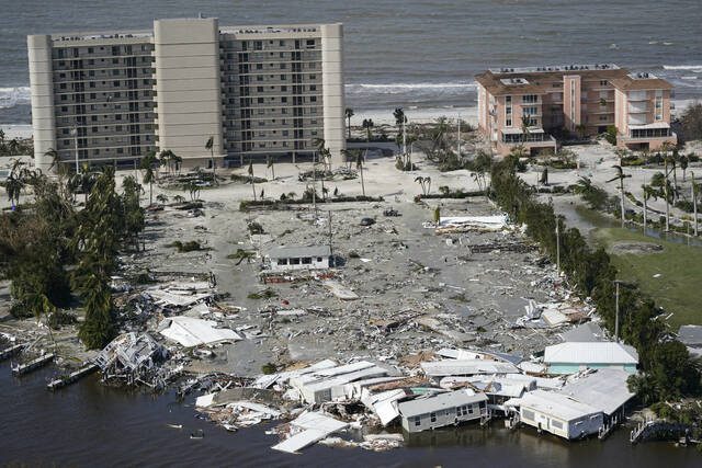 This aerial photo shows damaged homes and debris in the aftermath of Hurricane Ian, Thursday, Sept. 29, 2022, in Fort Myers, Fla. (AP Photo/Wilfredo Lee)
                                 Wilfredo Lee | AP