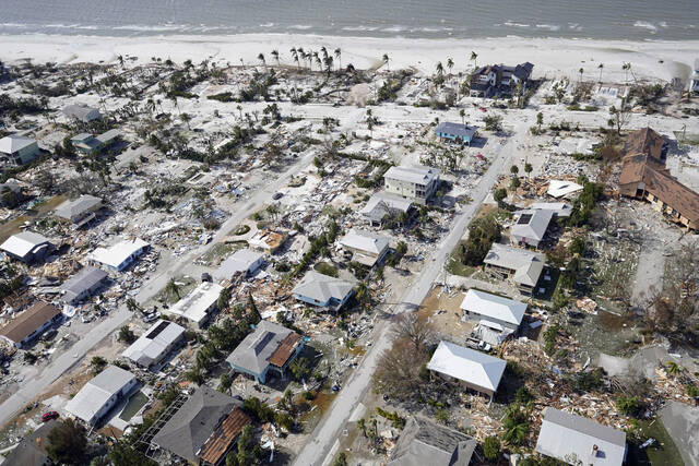 This aerial photo shows damaged homes and debris in the aftermath of Hurricane Ian, Thursday, Sept. 29, 2022, in Fort Myers, Fla. (AP Photo/Wilfredo Lee)
                                 Wilfredo Lee | AP