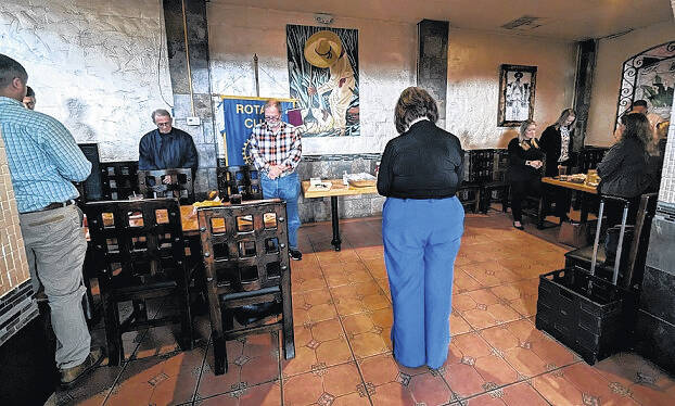 <p>Rotarians bow their heads in prayer before beginning the meeting.</p>
<p>Sara Fox | Bladen Journal</p>