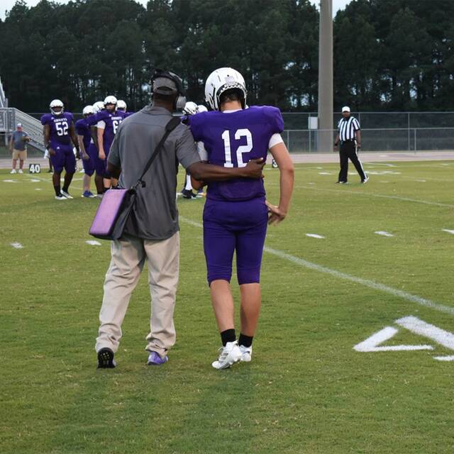 129880566_web1_WB_fbPREV
West Bladen quarterback Hunter Hester receiving instructions from his coach.
Alex Brooks| Bladen Journal