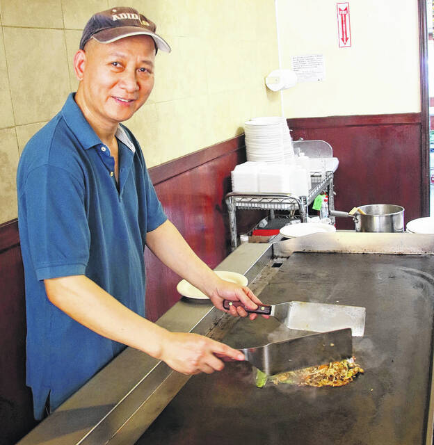 130508311_web1_IMG_8957
Shu Song Jiang has been at his Hibachi grill in Bladen County for 14 years and has been in America for 30 years. Although he speaks very little English, that which he does know, he picks up from his customers.
Mark DeLap | Bladen Journal
