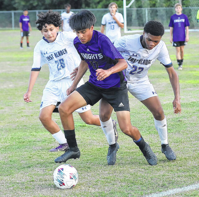 <p>West Bladen’s Alejandro Lopez Sandoval (17) tries to control the ball while being defended by East Bladen’s J.D. McArthur (22) and a teammate on Wednesday.</p>
                                 <p>Kenneth Armstrong / kenarmphoto.com</p>
