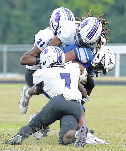 <p>West Bladen’s Sincere McKinley (7), Isaiah Robinson (23) and Tashawn Carter (25) team up to tackle a Heide Trask player.</p>
<p>Kenneth Armstrong / kenarmphoto.com</p>