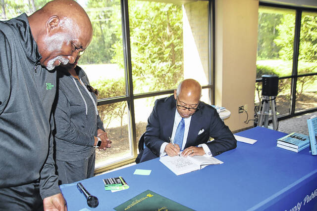 131800537_web1_556959301_1427016916098638_3582834602612997261_n
Dennis Troy who is the Chair for Bladen Community College pauses a moment as there were many people in line to have Dr. William Keyes sign a copy of his book, The Stories They Hear. Dr. Keyes was a special motivational speaker Oct. 2 at Bladen Community College.
Mark DeLap | Bladen Journal