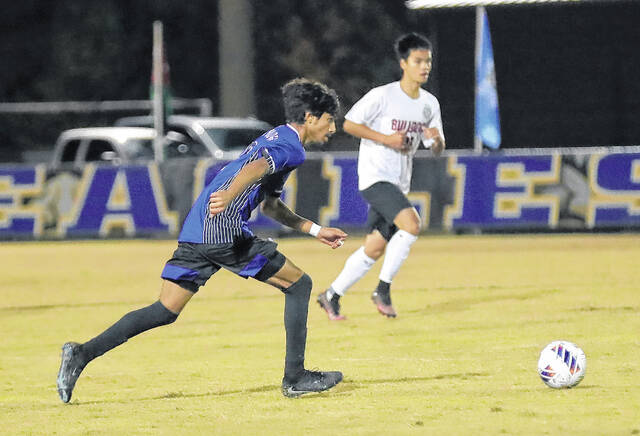 131909795_web1_East_Bladen_Roxboro_soccer_02
East Bladens Ishaq Algozy (blue) dribbles the ball against Roxboro Community.
Kenneth Armstrong / <a href="https://www.kenarmphoto.com/" target="_blank">kenarmphoto.com</a>