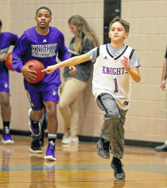<p>Jackson Pait leads the West Bladen Knights onto the court in 2018 prior to a game against East Columbus.</p>
<p>Kenneth Armstrong / kenarmphoto.com</p>