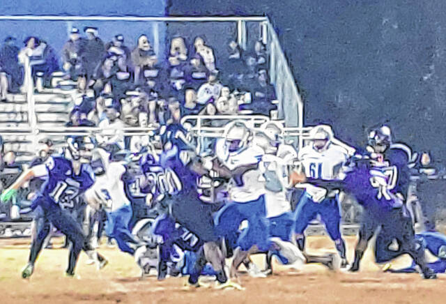 <p>East Bladen (white) and West Bladen (purple) players battle during Thursday’s football game at Bladenboro Middle School.</p>
<p>Sonny Jones / Bladen Journal</p>