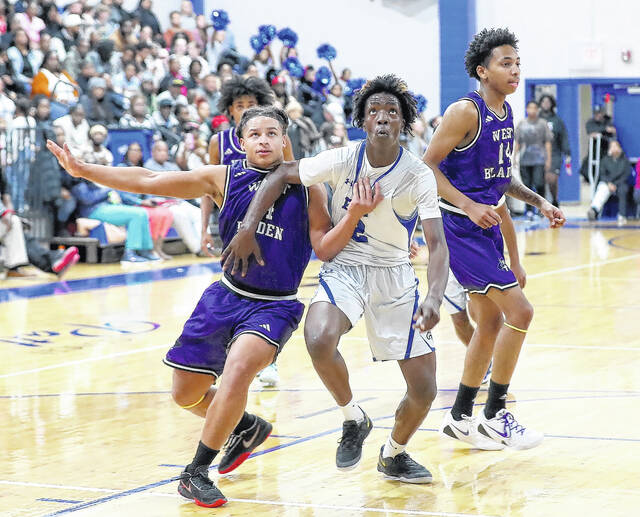<p>West Bladen’s Justin Spaulding (34) and East Bladen’s Keyshawn Kemp (2) battle for position for a rebound.</p>
<p>Kenneth Armstrong / kenarmphoto.com</p>