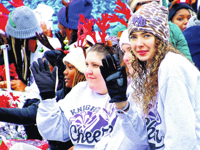 <p>A cheer team from West Bladen High School were not only wearing warm festive clothes and festive accessories, but bundled together to help stay warm.</p>
