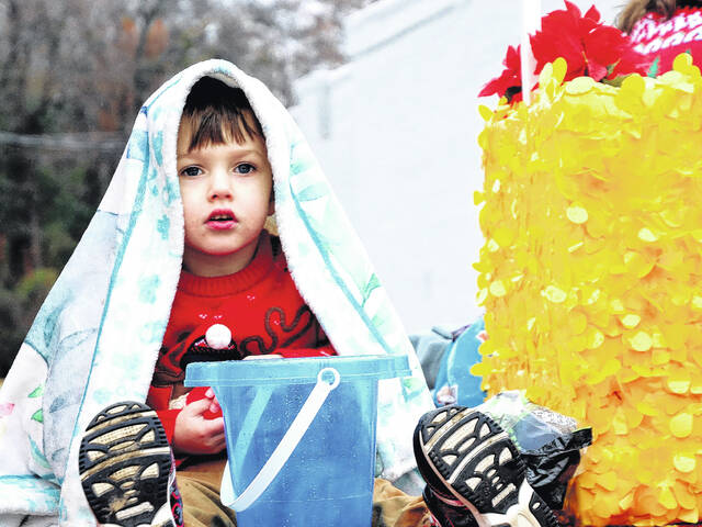 <p>Some float goers brought warm clothing and huddled and cuddled under warm blankets. One child was in charge of the candy bucket which was a pretty prominent position to be in.</p>