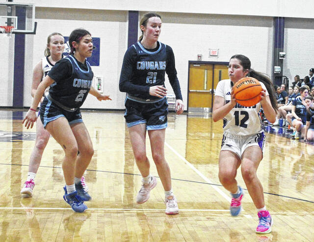 <p>West Bladen’s Hadley Dove (12) looks for an open teammate as South Brunswick’s Aubree Adams (21) and Vivian Cruz (25) guard her.</p>
<p>Sonny Jones / Bladen Journal</p>