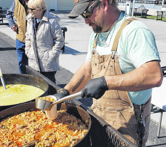 <p>Adam Smith pours a ladle full of his Brunswick stew into a cup for hungry customers.</p>
<p>Sonny Jones / Bladen Journal</p>