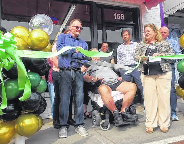 Aaron Bullock cuts the ribbon Friday, Feb. 20 to officially open E-Town Nutrition. The store features Herbalife products.
Contributed photo
