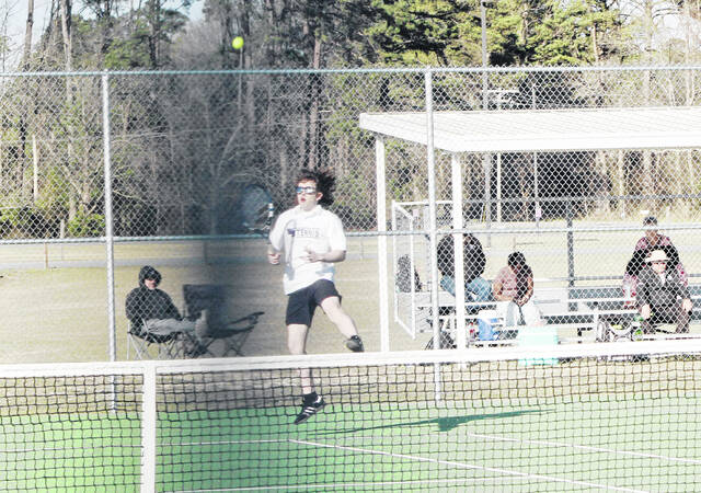 A West Bladen tennis player tries to return a shot against East Bladen.