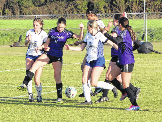 East Bladen and West Bladen players battle for the soccer ball.