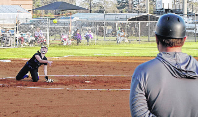 West Bladen pitcher Allison Hickman makes a throw to first base while on her knees against East Bladen.
