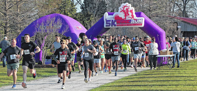 Runners leave the starting line in the Wine Run 5k at Lu Mil Vineyard on Saturday.
                                 Sonny Jones / Bladen Journal