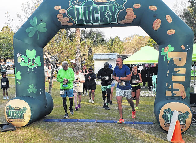 Runners start the Lucky 10k race Saturday at Cape Fear Vineyard & Winery.
                                 Sonny Jones / Bladen Journal