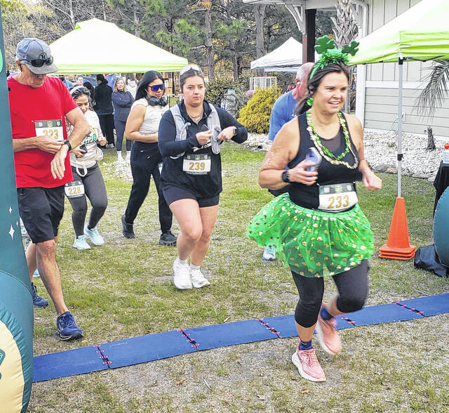 Elizabethtowns Jacquelyn Nance wears a green tutu as she participates in the Lucky Half-Marathon at Cape Fear Vineyard & Winery.
                                 Sonny Jones / Bladen Journal