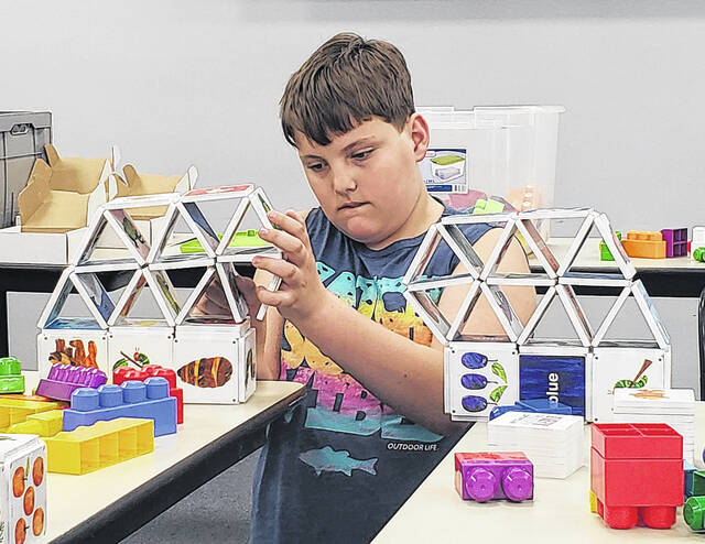 Corbin Norris works on building his bridge with Magna-Tiles at the Bladen County Public Librarys Hangout Hub.
                                 Sonny Jones / Bladen Journal