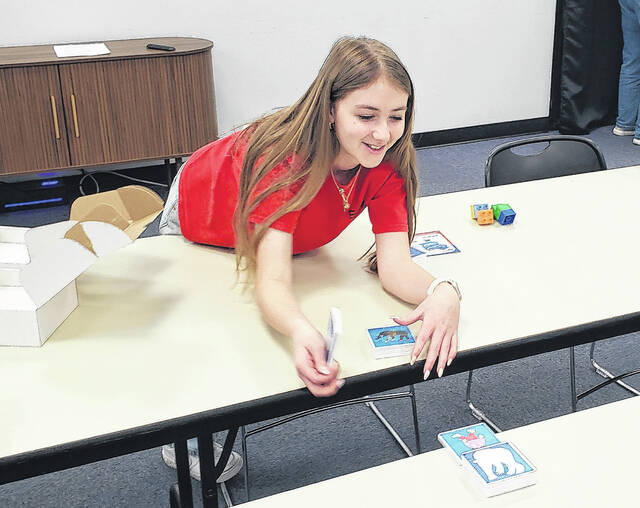 Mia Thompson watches her bridge of Magna-Tiles fall to the floor.
                                 Sonny Jones / Bladen Journal