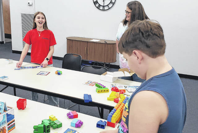 Mia Thompson (left), Bladen County Public Library assistant Miranda Johnson (center) and Corbin Norris share a laugh during Hangout Hub.
                                 Sonny Jones / Bladen Journal