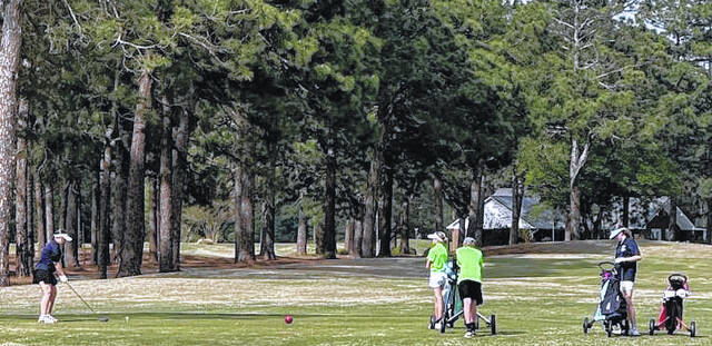 An Elizabethtown Christian (far left) prepares to hit a shot as playing partners look on Monday in a match against Emereau: Bladen
Contributed photo