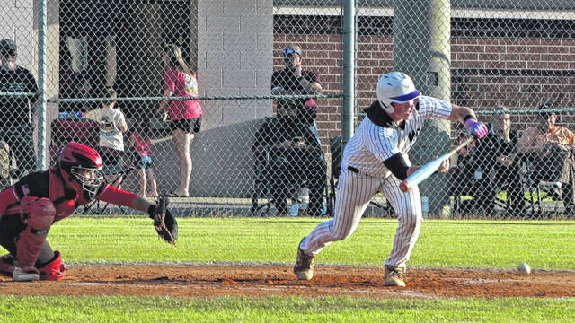 West Bladens Weston Hilburn lays down a sacrifice bunt against Red Springs.
                                 Sonny Jones / Bladen Journal