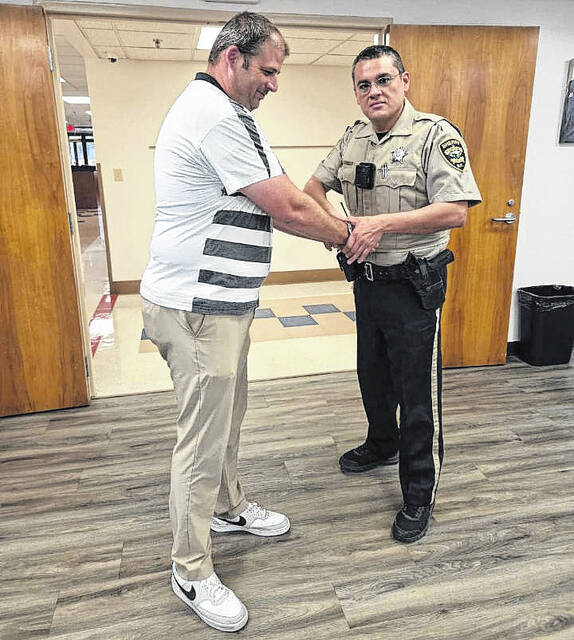 West Bladen principal Chris Orrock has his handcuffs removed after being arrested as part of the Bladen County Educational Foundation Jail-A-Thon on Thursday, April 23.
                                 Contributed photo