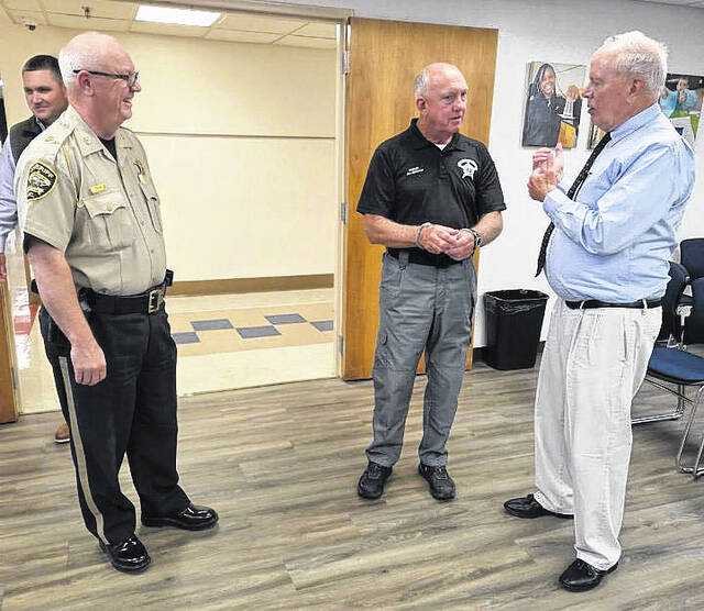 Bladen County Sheriff Jim McVicker (center) talks with Bladen County Educational Foundation treasurer David Wall during the Thursday, April 23 Jail-A-Thon.
                                 Contributed photo