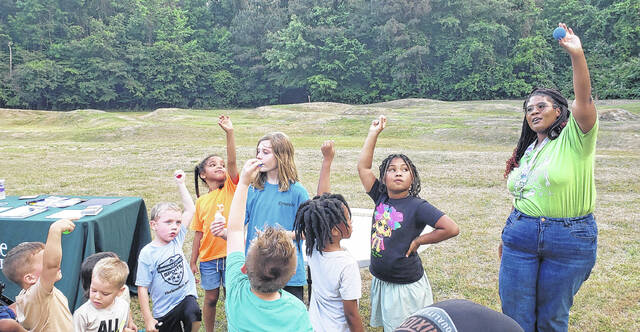Bladen County Public Librarys Jasmine Peterson holds up a ball signifying Earth during a discussion about planets.
                                 Sonny Jones / Bladen Journal