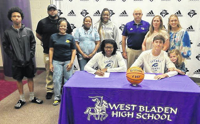 The families of West Bladens Tylik McCall, left, and Jackson Pait at the signing ceremony for the pair to play basketball at Chowan.
                                 John Clark photo