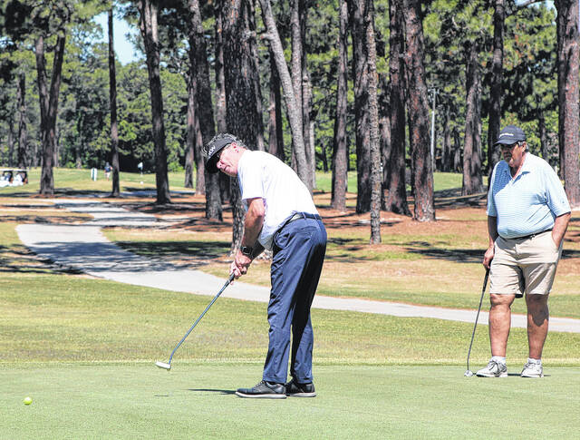 A golfer putts the ball on No. 9 Friday. The putt went in the hole for a birdie for his team.
Sonny Jones / Bladen Journal