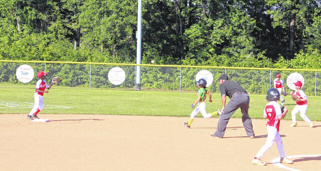 Bladen County second baseman Cotton Heverly (right) throws to shortstop Ayden Wilds for a force out at second base against Columbus County.
                                 Sonny Jones / Bladen Journal