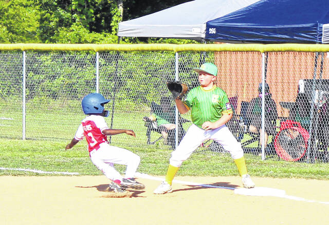 Bladen Countys Ayden Wilds slides safely into first base after a line drive was caught by a Columbus County player.
                                 Sonny Jones / Bladen Journal