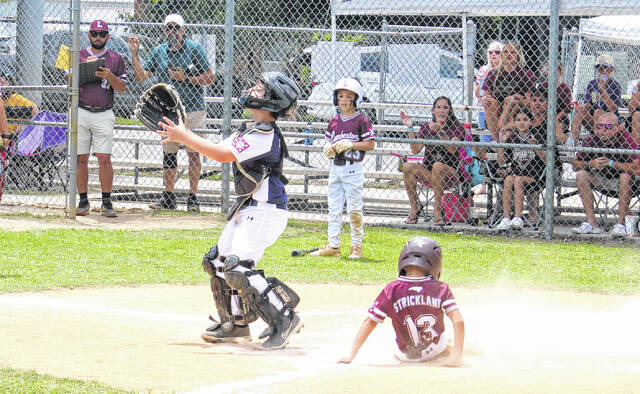 Elizabethtown catcher Henry Peed awaits a throw as Lumberton Maroons Colby Strickland (13) slides across home plate in the DYB District 9 Coach-Pitch tournament Saturday, June 6 at Leinwand Park.
Sonny Jones / Bladen Journal